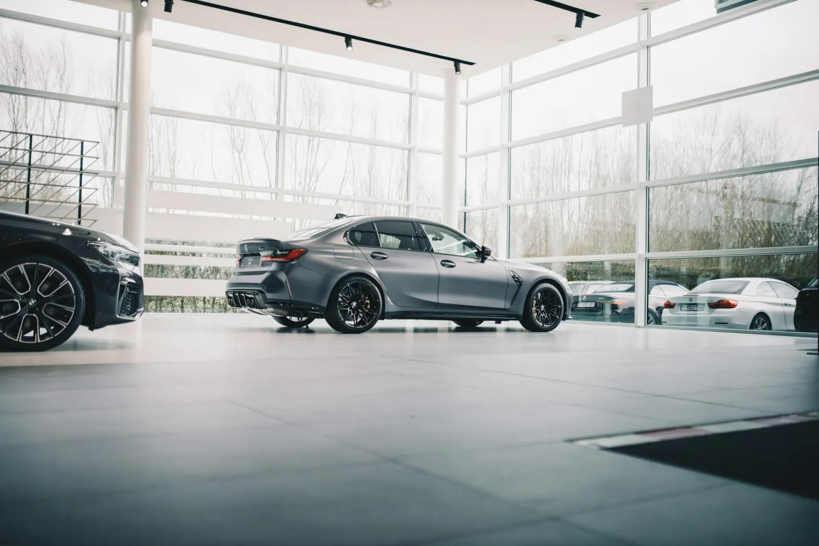 Grey BMW M3 in a glass showroom