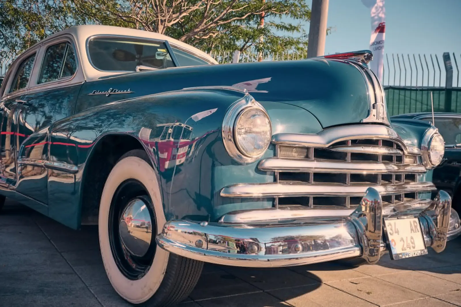 Teal classic Pontiac with chrome grille